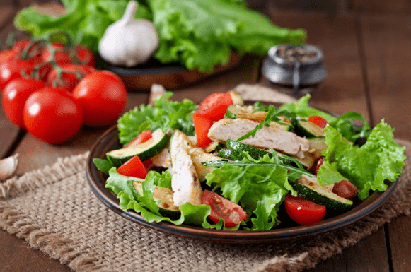 Chicken and green salad is a great option for a light post-workout dinner. 